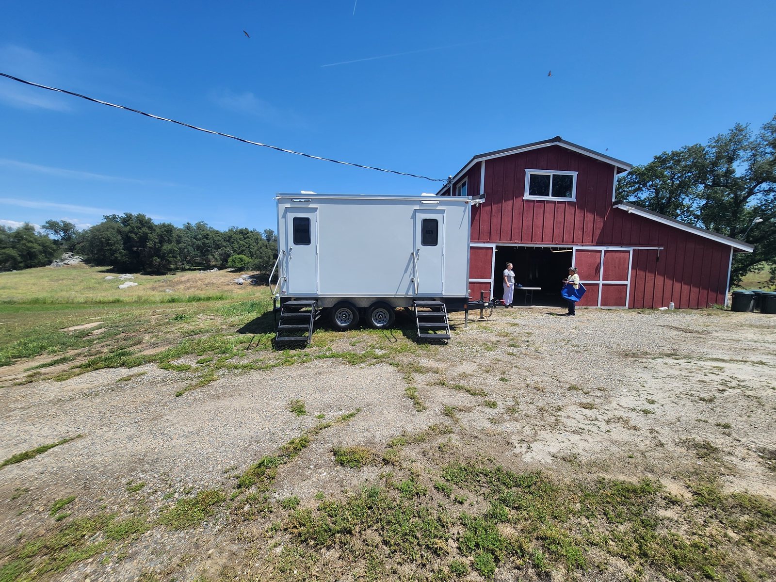 2 station restroom trailer staged at the rural barn, an Oregon restroom trailer rental job