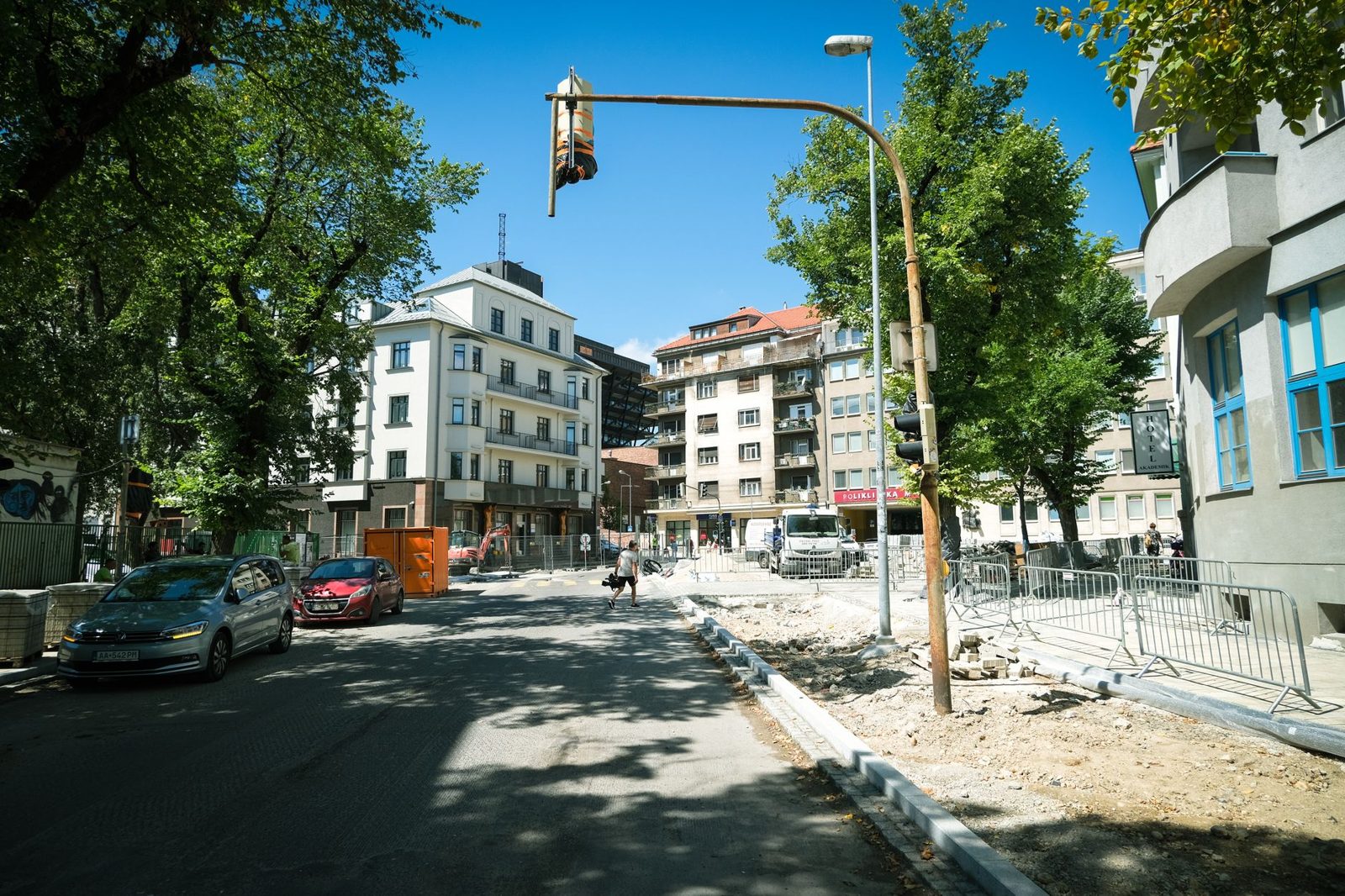 A city street with trees and parked cars
