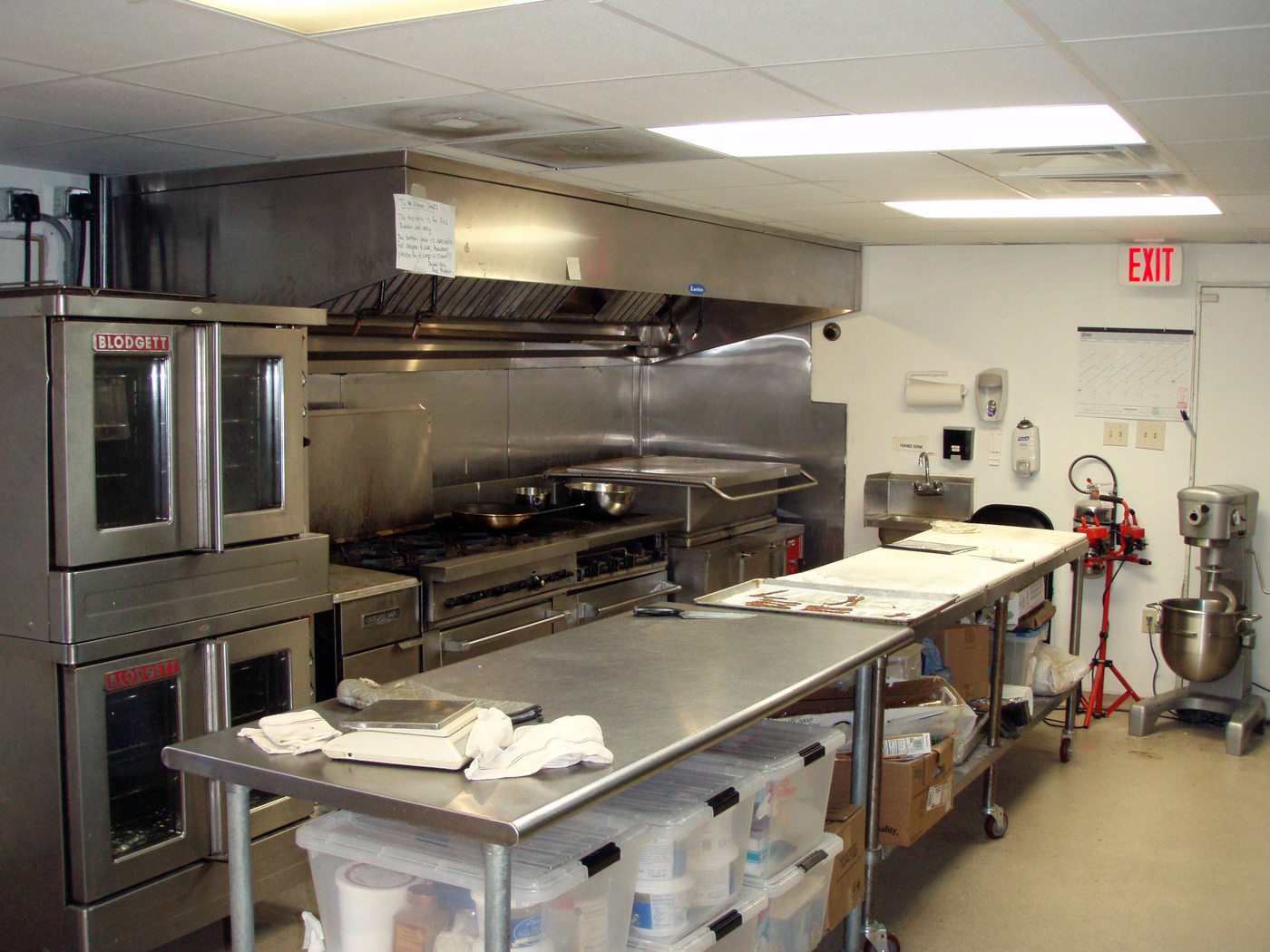 Commercial cook line in full production with the crew working stations under the hoods