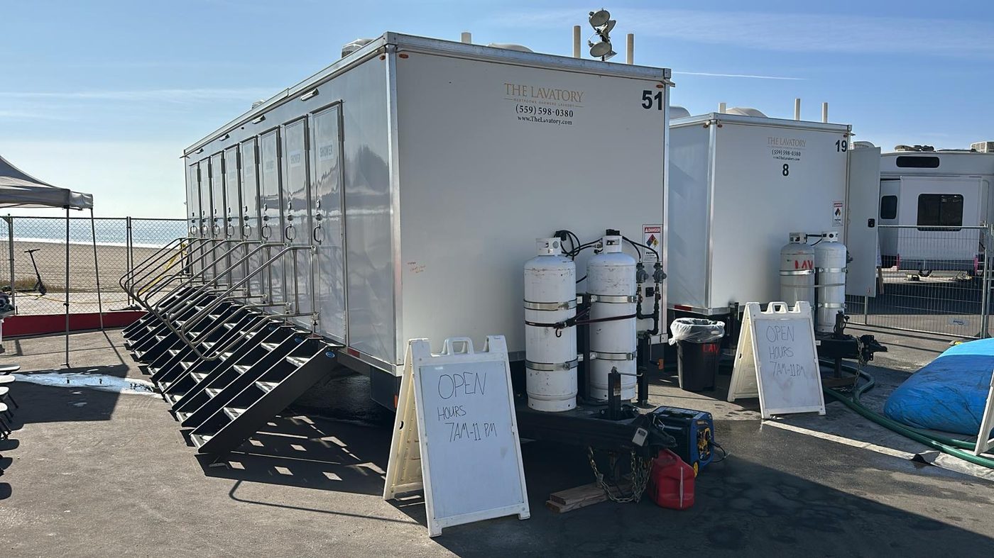 Decon trailer positioned outside a remediation containment with the wash line ready for shift end