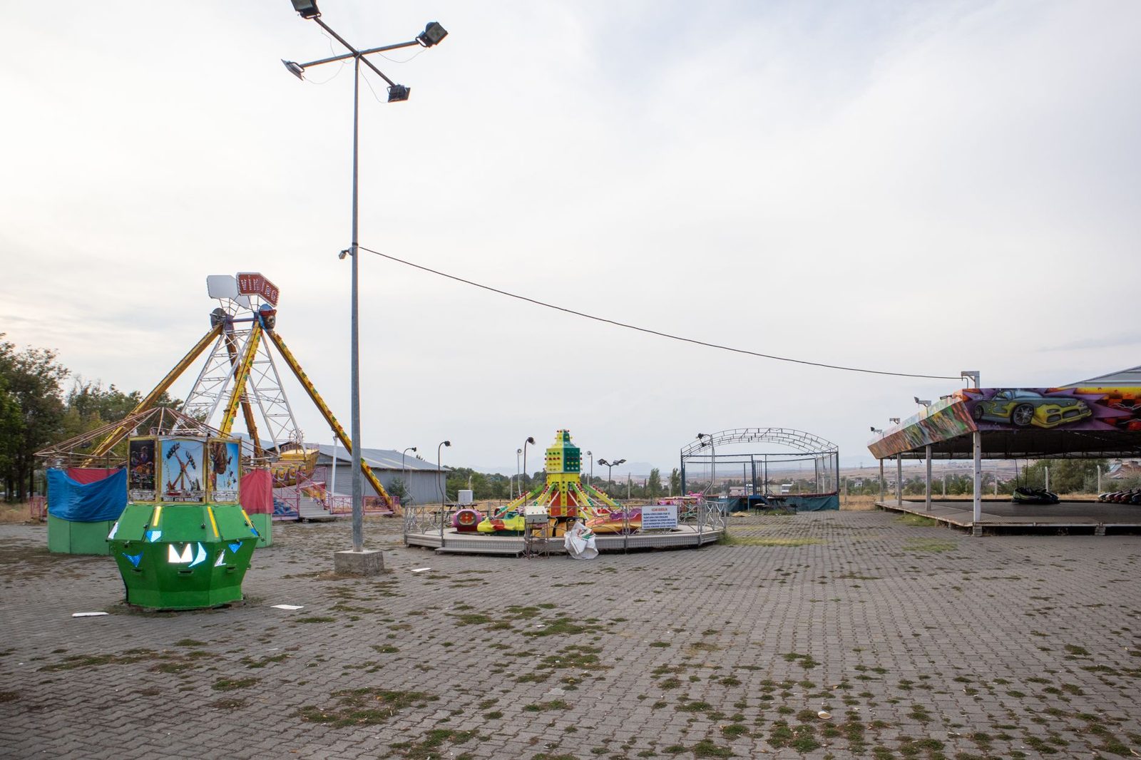 An empty fairground lot with the rides shut down