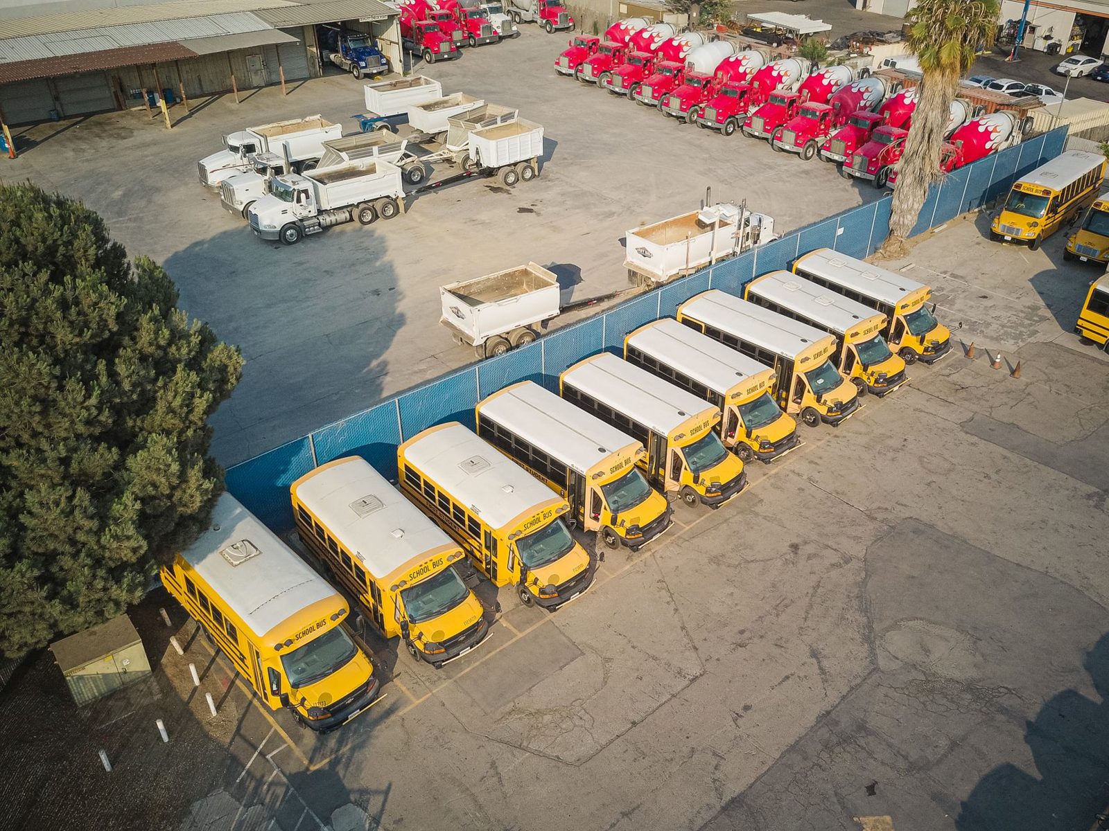 A fleet of buses lined up in a large lot, ready to move evacuees