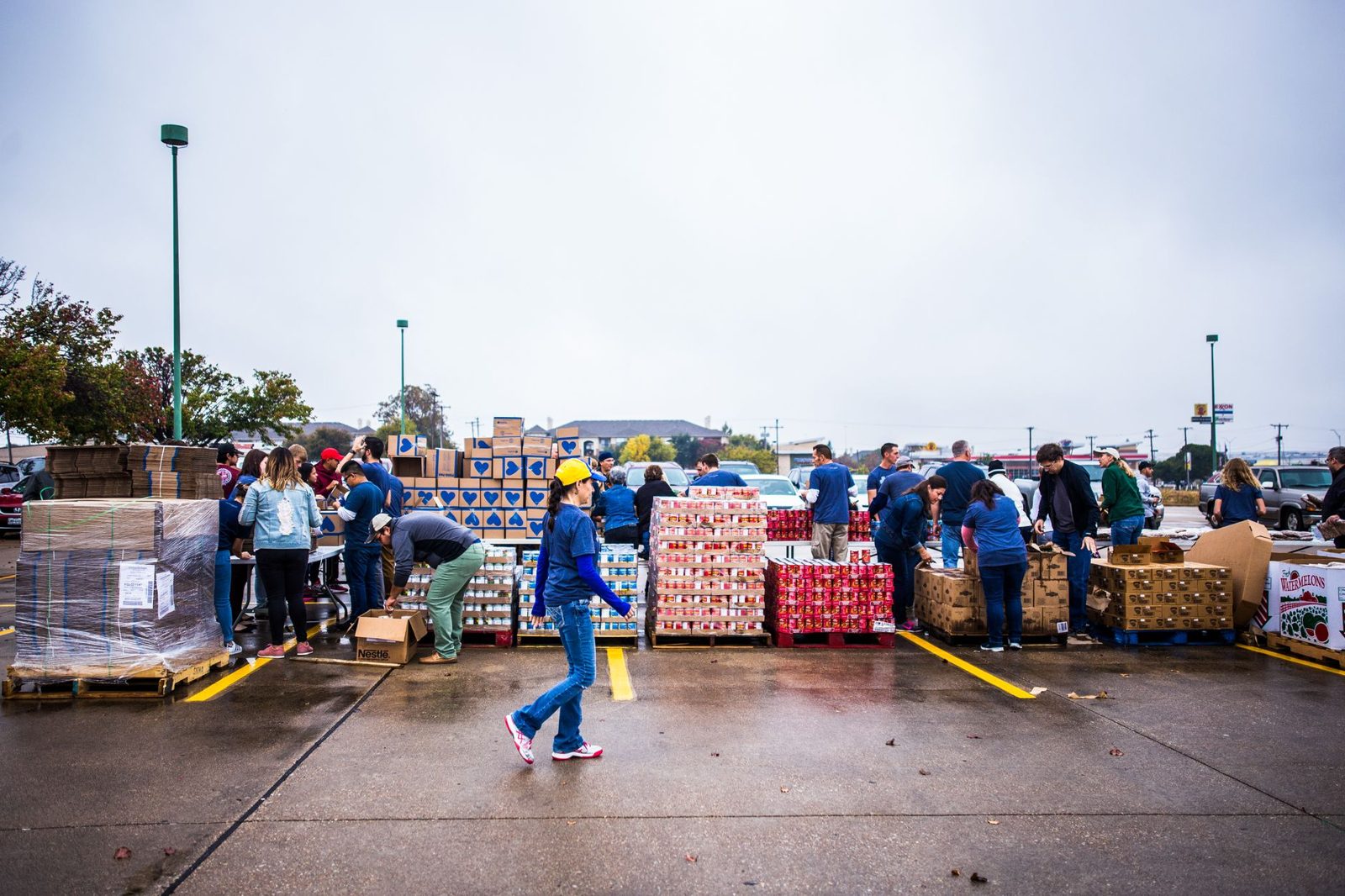 Volunteers moving boxes at an outdoor food distribution