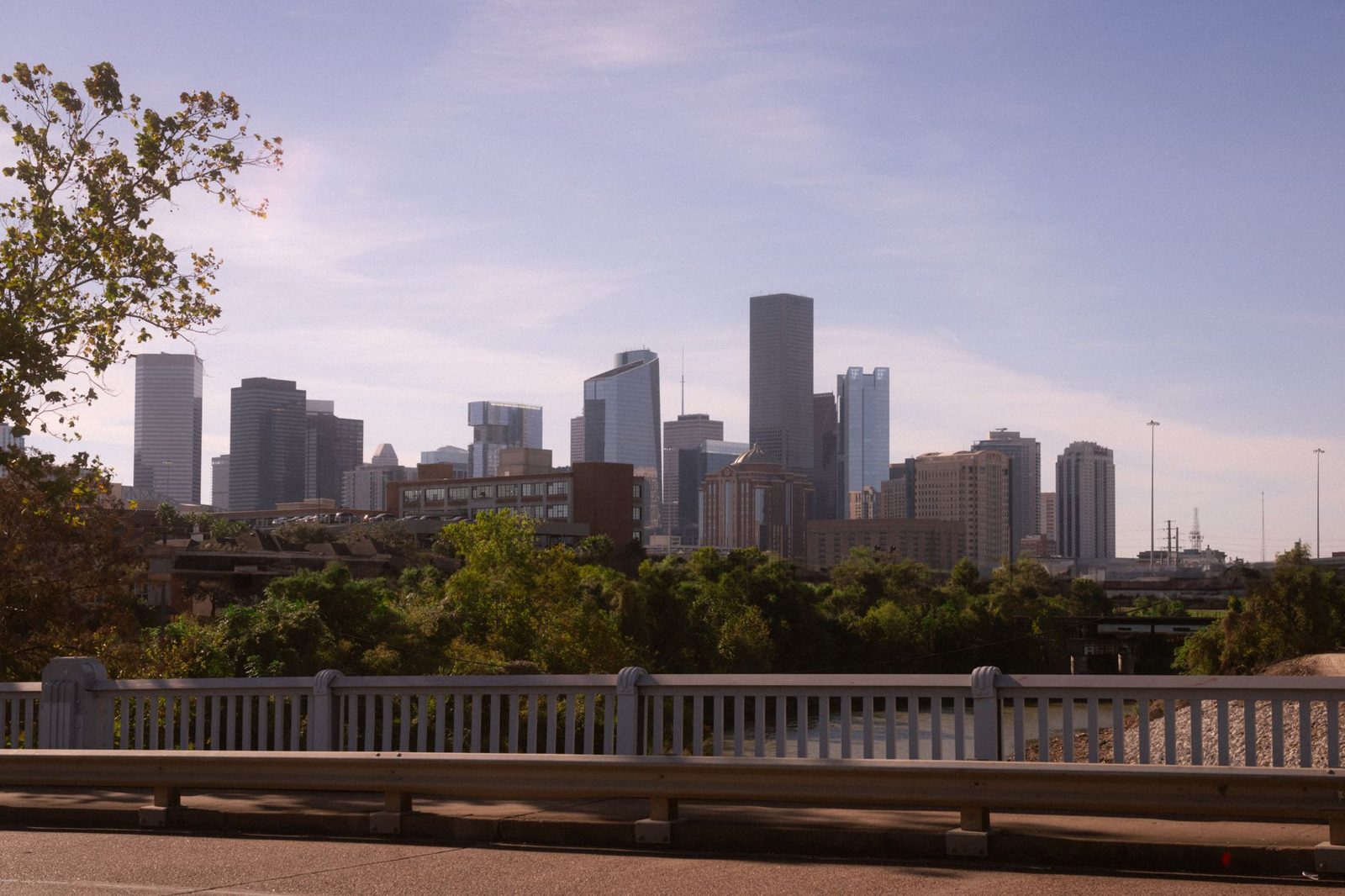 The Houston skyline above a bayou bridge