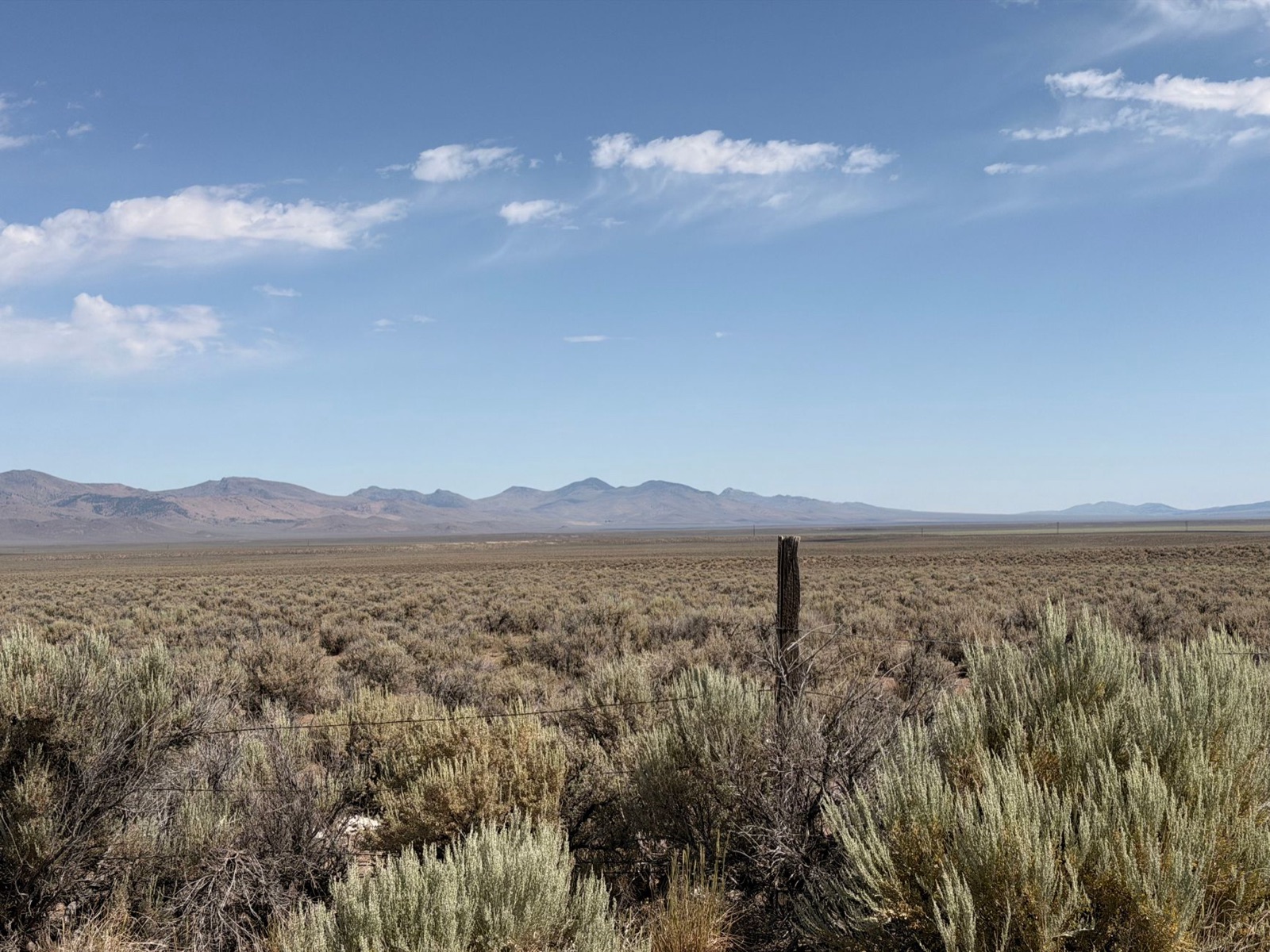 Open sagebrush flats under a wide sky, the kind of remote country where fire crews set up camp