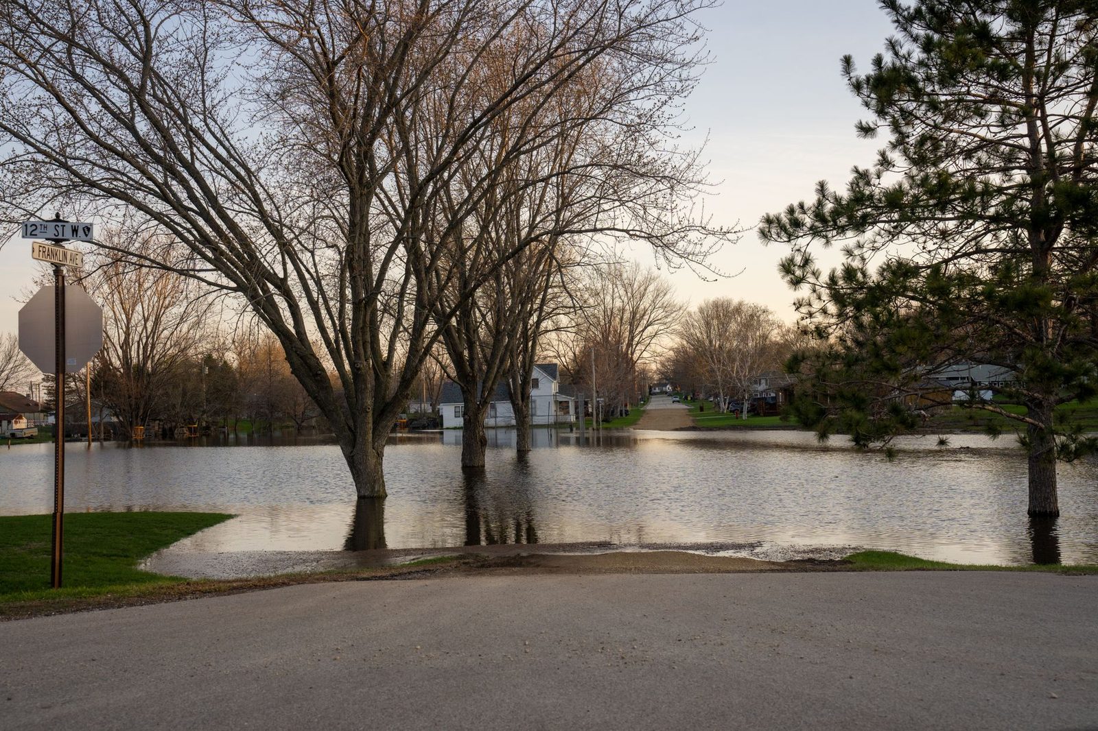 Floodwater spreading across a park after heavy rain