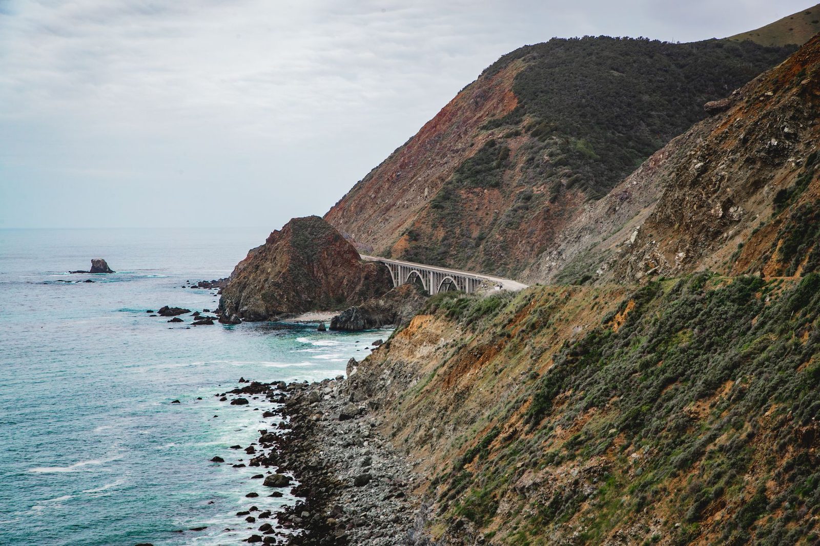 Steep coastal cliffs dropping to the sea along a winding shoreline