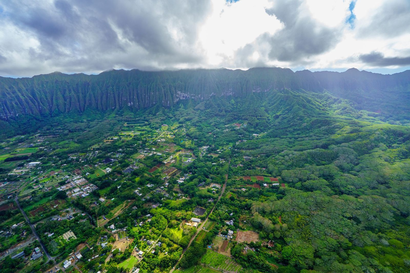 Oahu neighborhoods spread across the plain below the Koolau Range