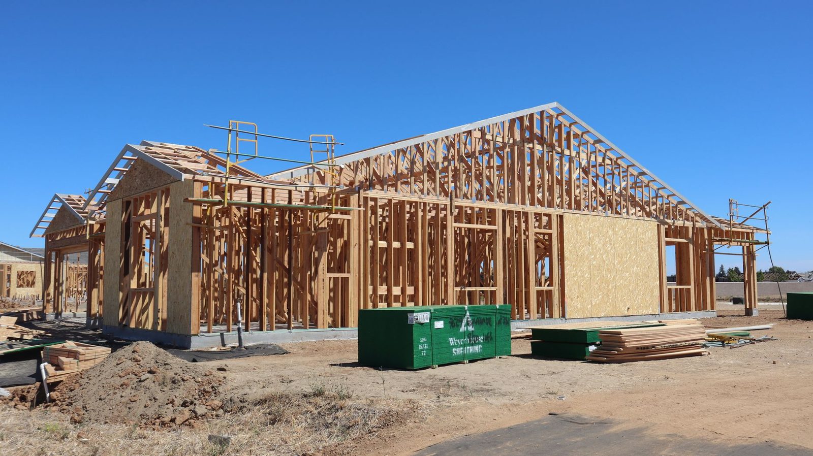 New house framing going up on a cleared lot