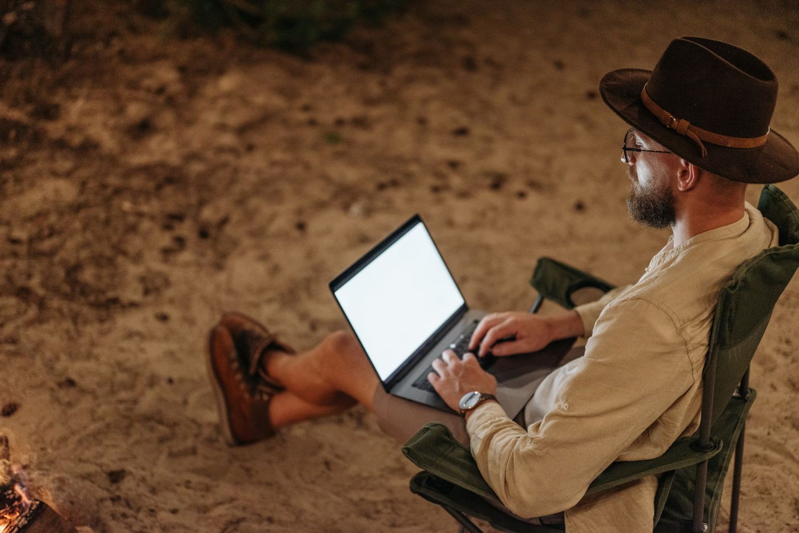 A worker with a laptop at a remote desert site