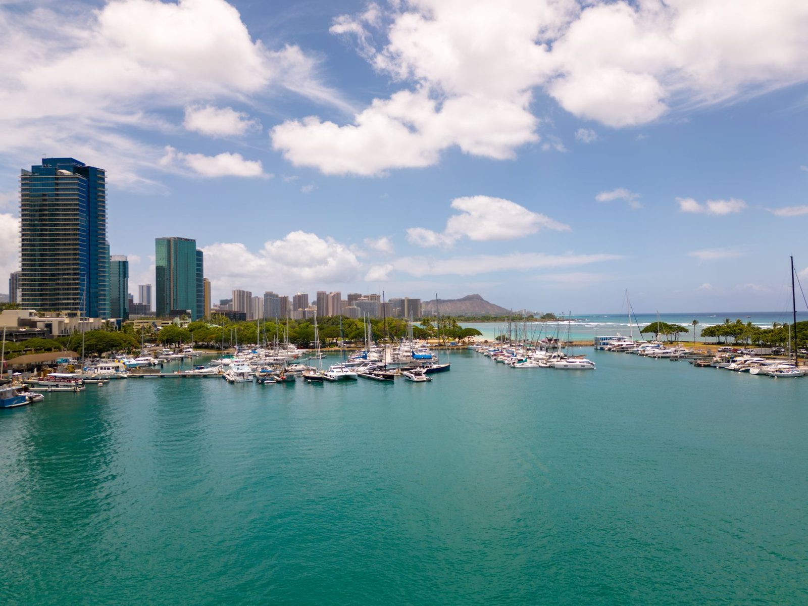 Kewalo Basin harbor in Honolulu with Diamond Head behind