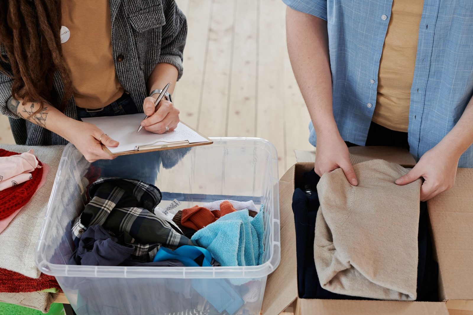 Volunteers sorting donated clothing into bins at a relief center