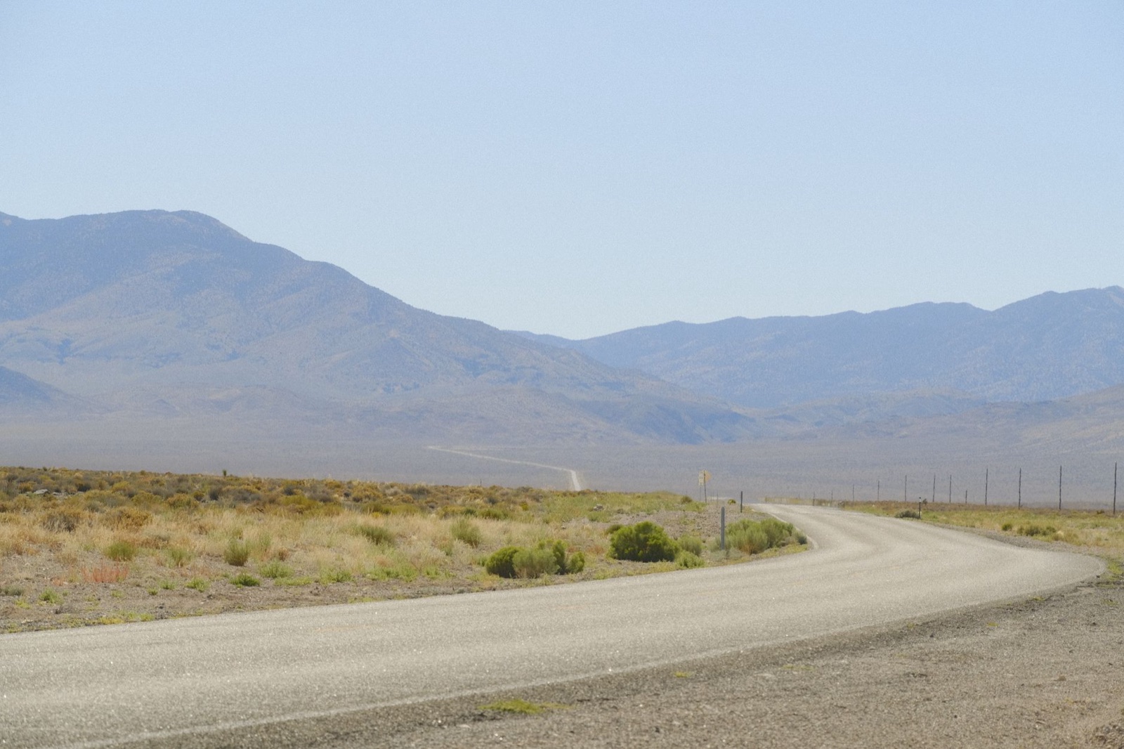 A desert highway through Nye County, Nevada toward distant mountains