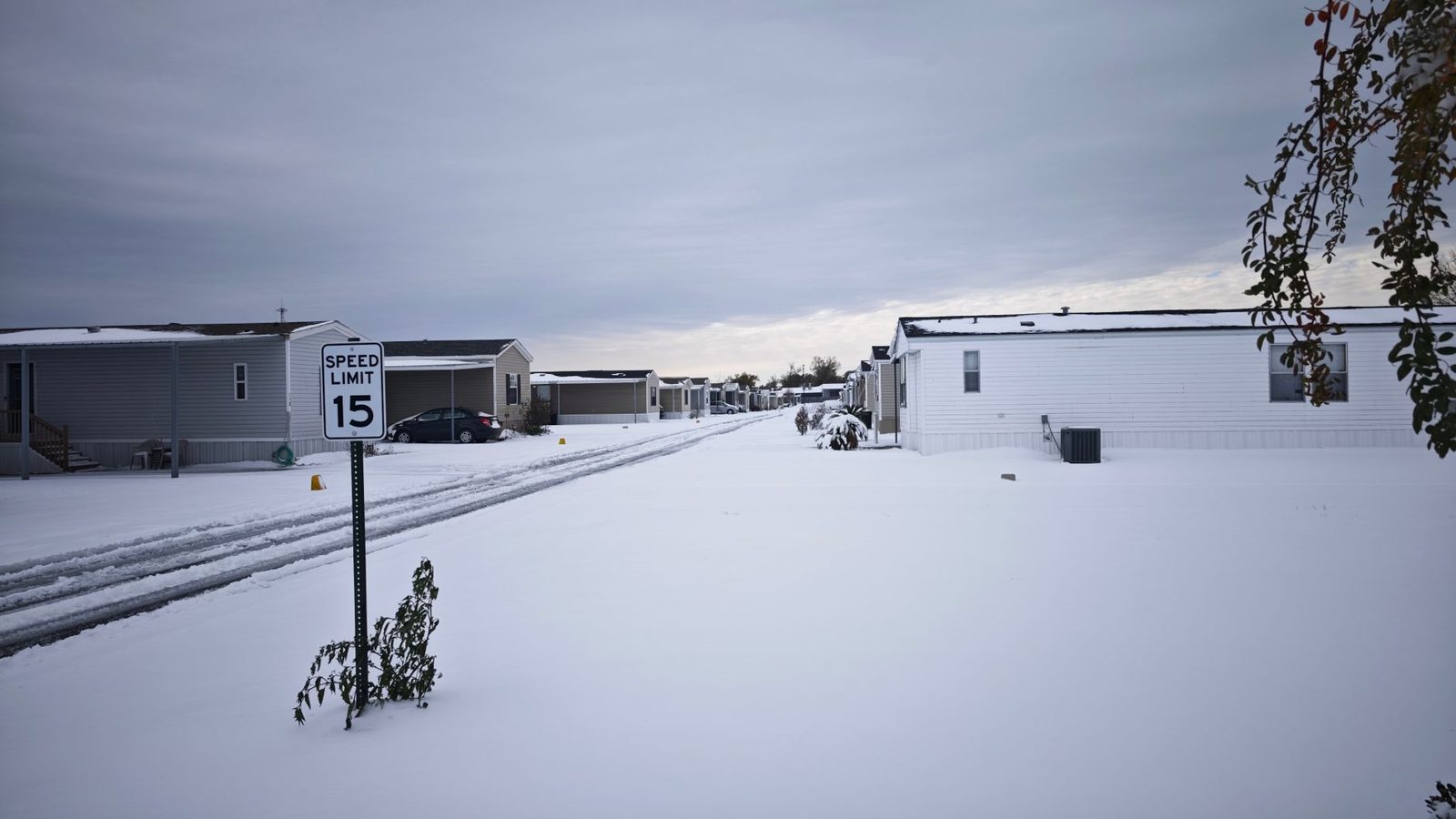 Snow covering a lot of parked trailers