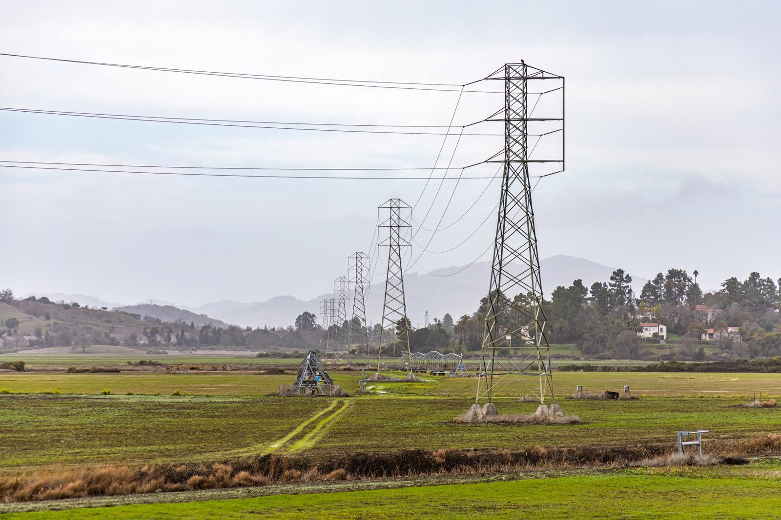 High voltage transmission towers crossing open country