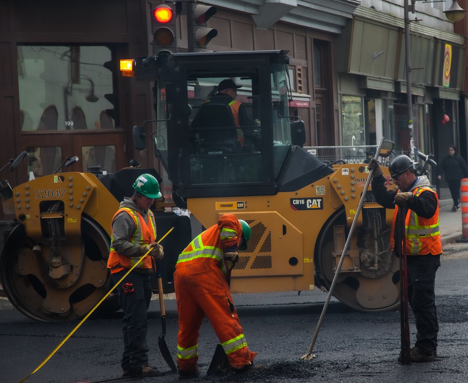 A road crew paving a city street on a sunny day