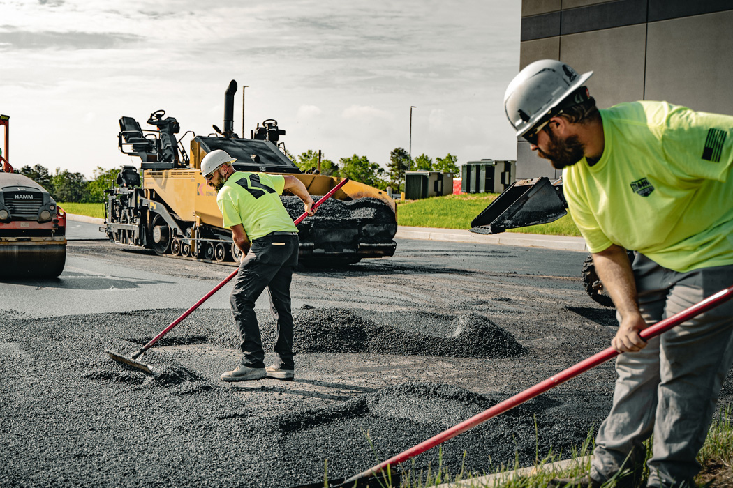 Construction crew paving a Sacramento road in summer heat
