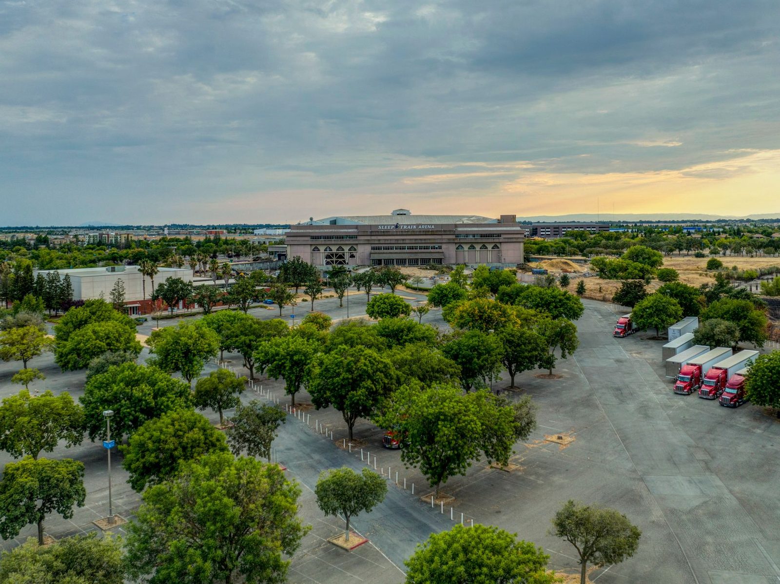 A large campus parking lot lined with trees