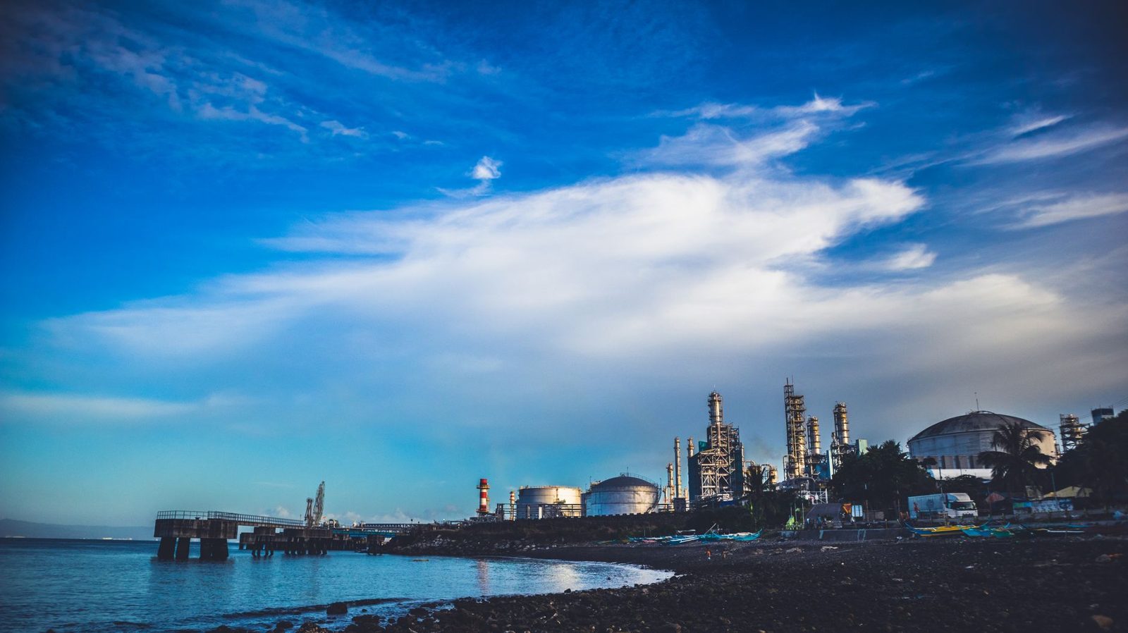 A refinery skyline across the water on the Gulf Coast
