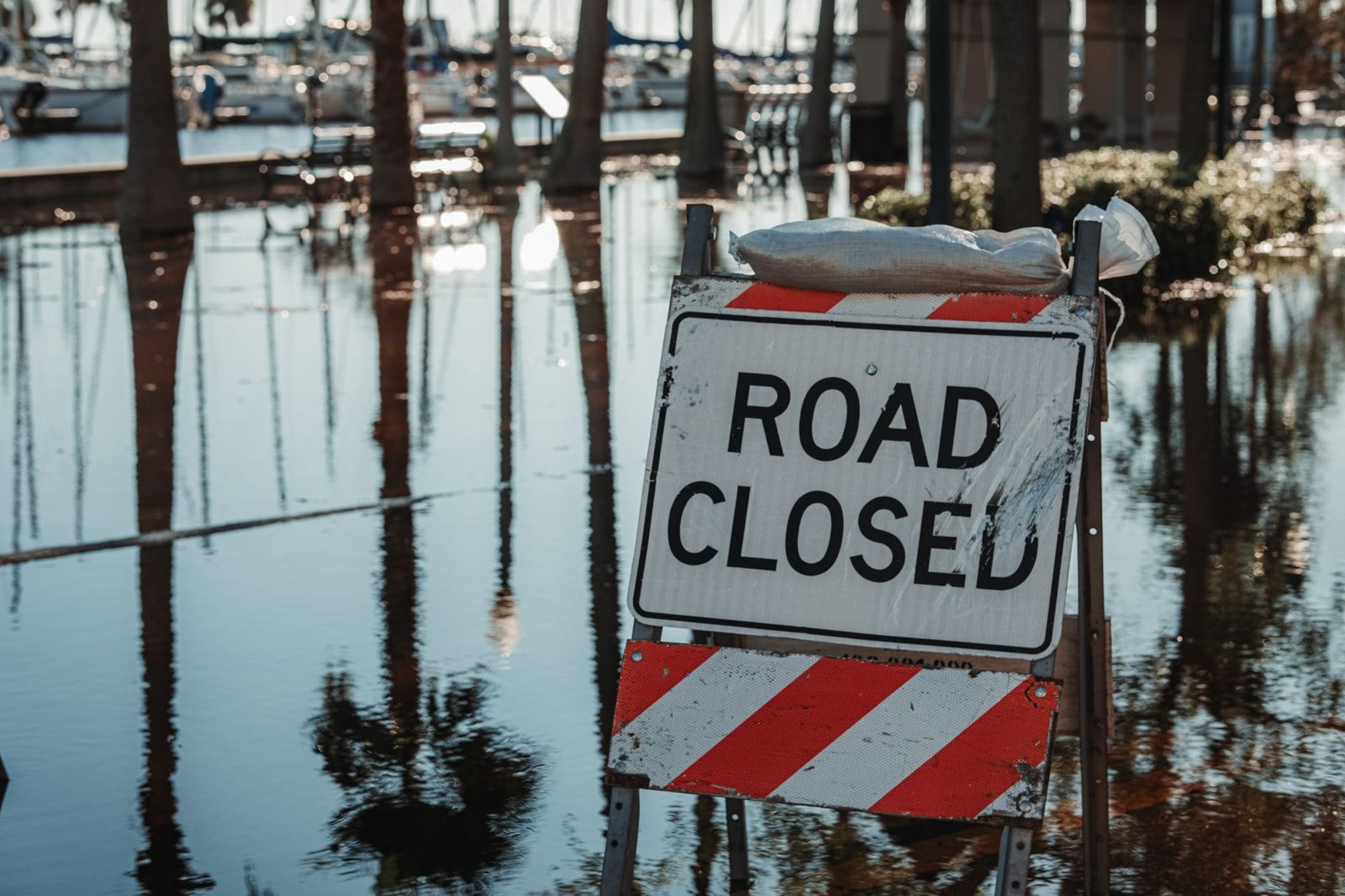 A road closed sign standing in floodwater