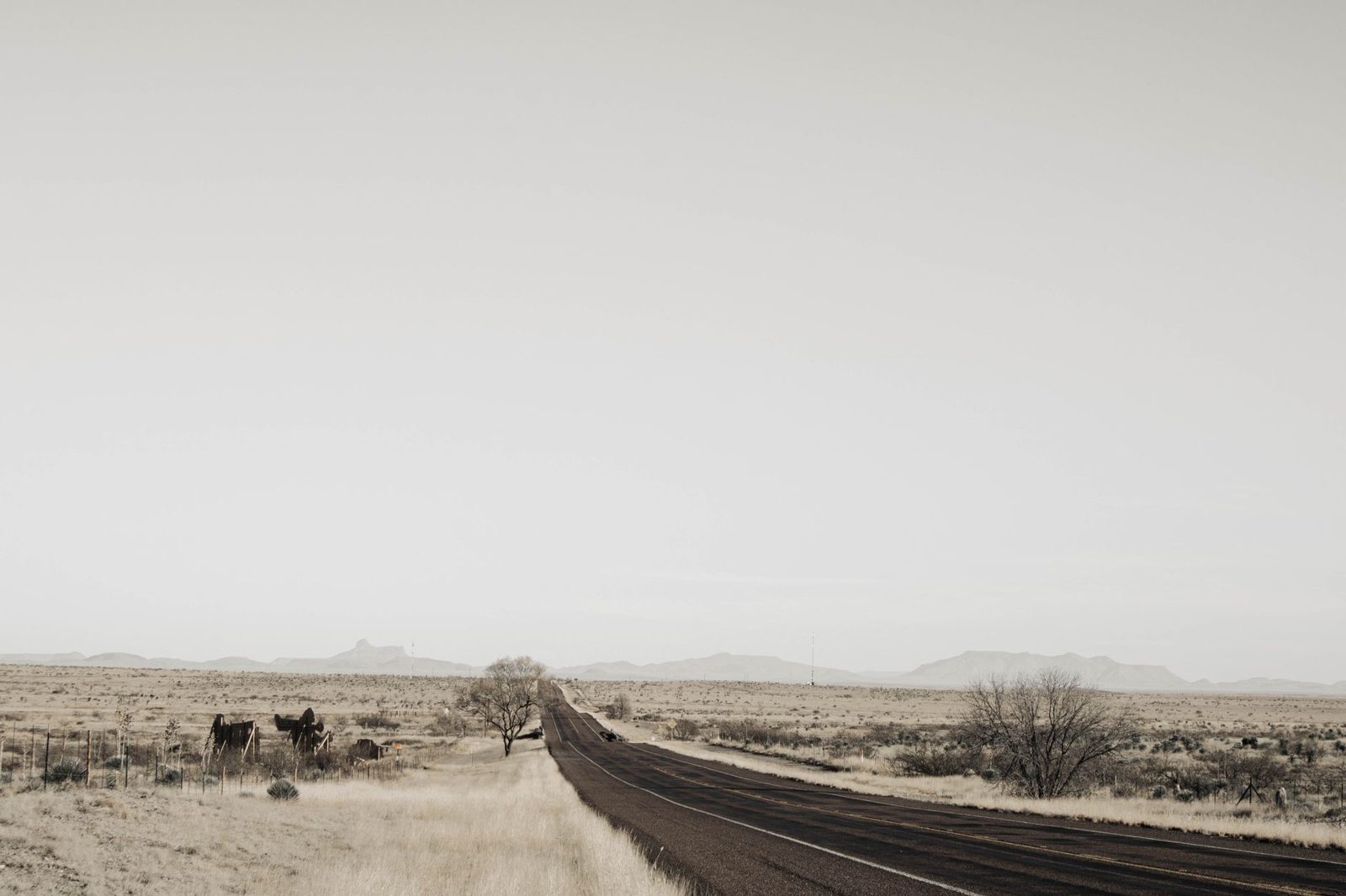 A dirt road running across dry West Texas range