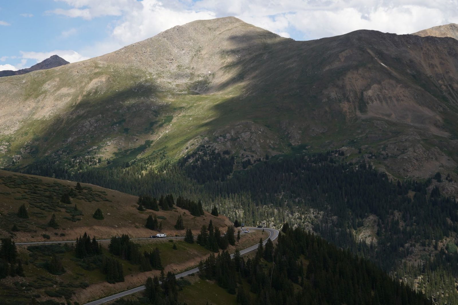 A highway winding through a high Rocky Mountain valley