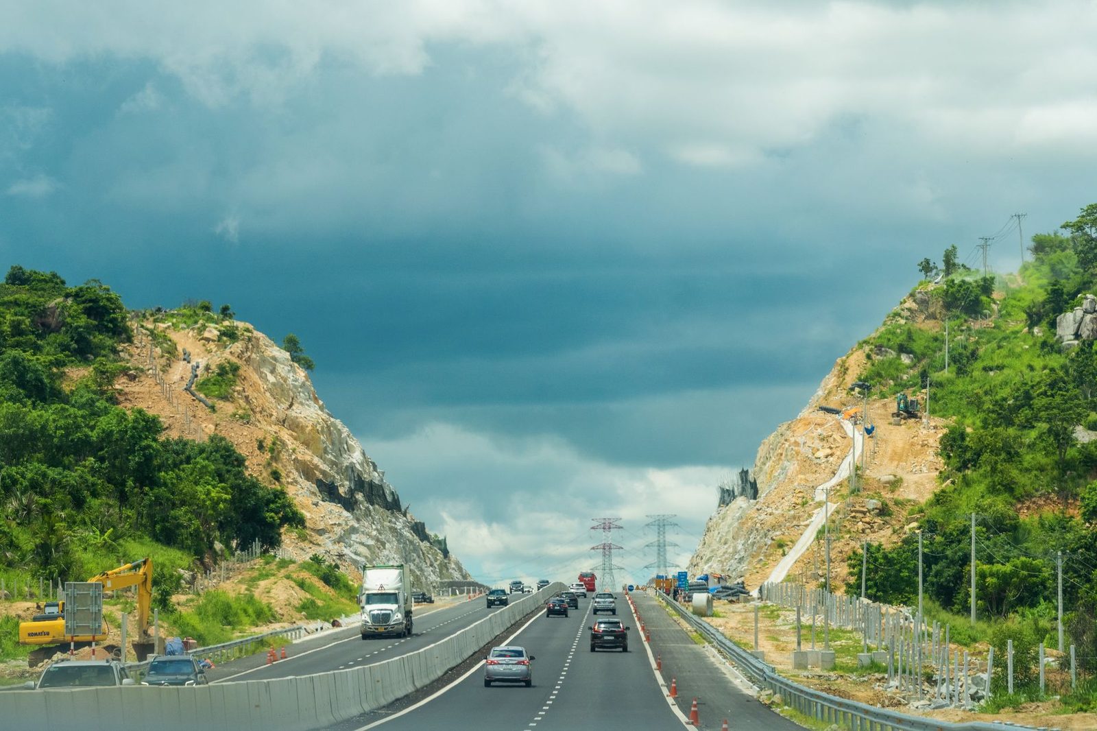 A divided highway running through dry mountain slopes on the way to a remote job site