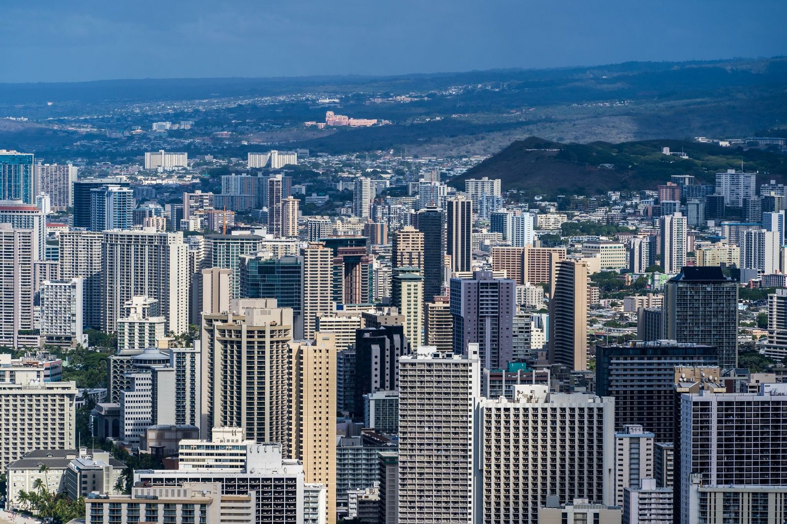 The dense core of Honolulu from above, with towers running back toward the ridges