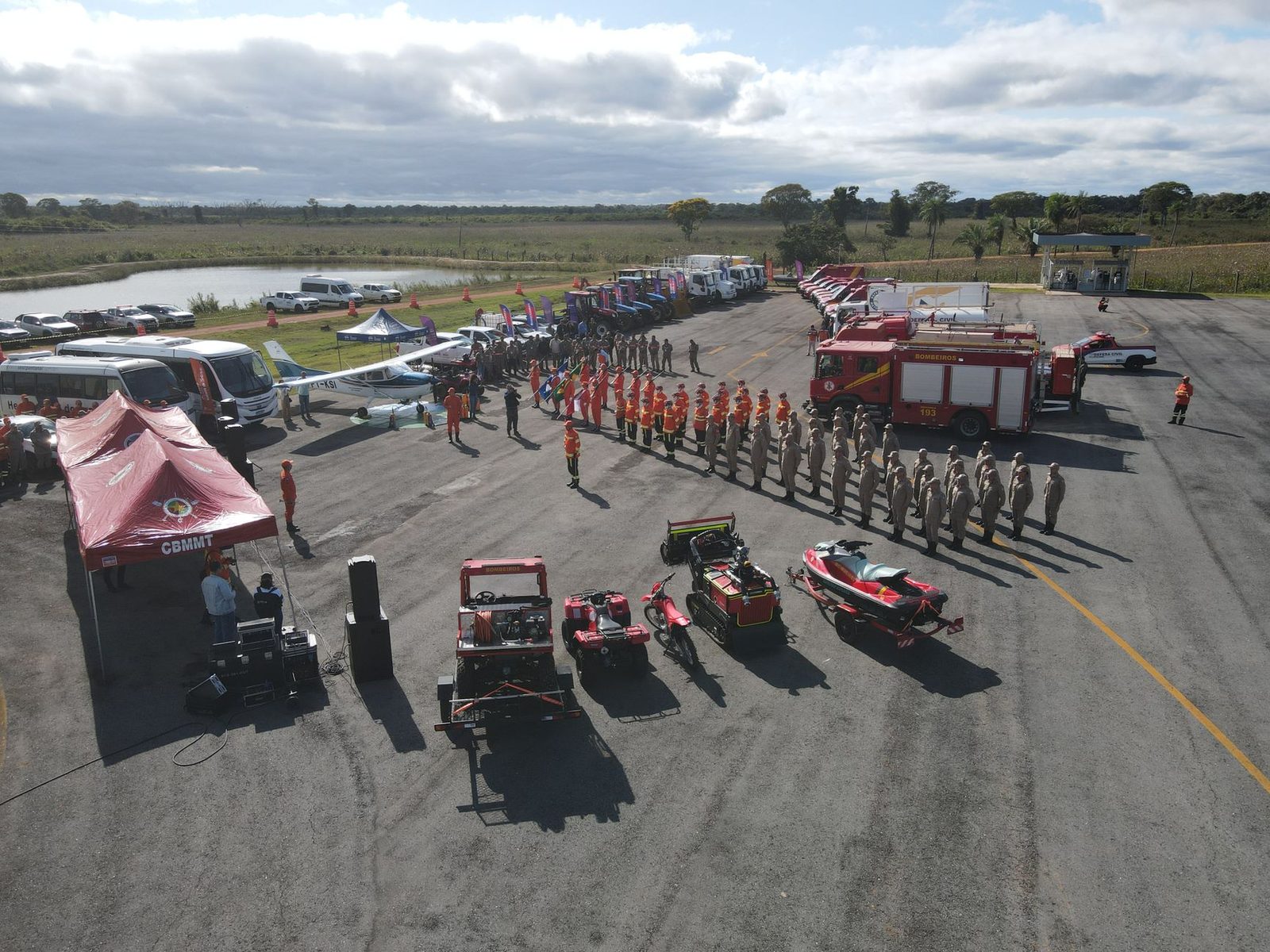 Fire engines, crews and support gear lined up at an outdoor staging area