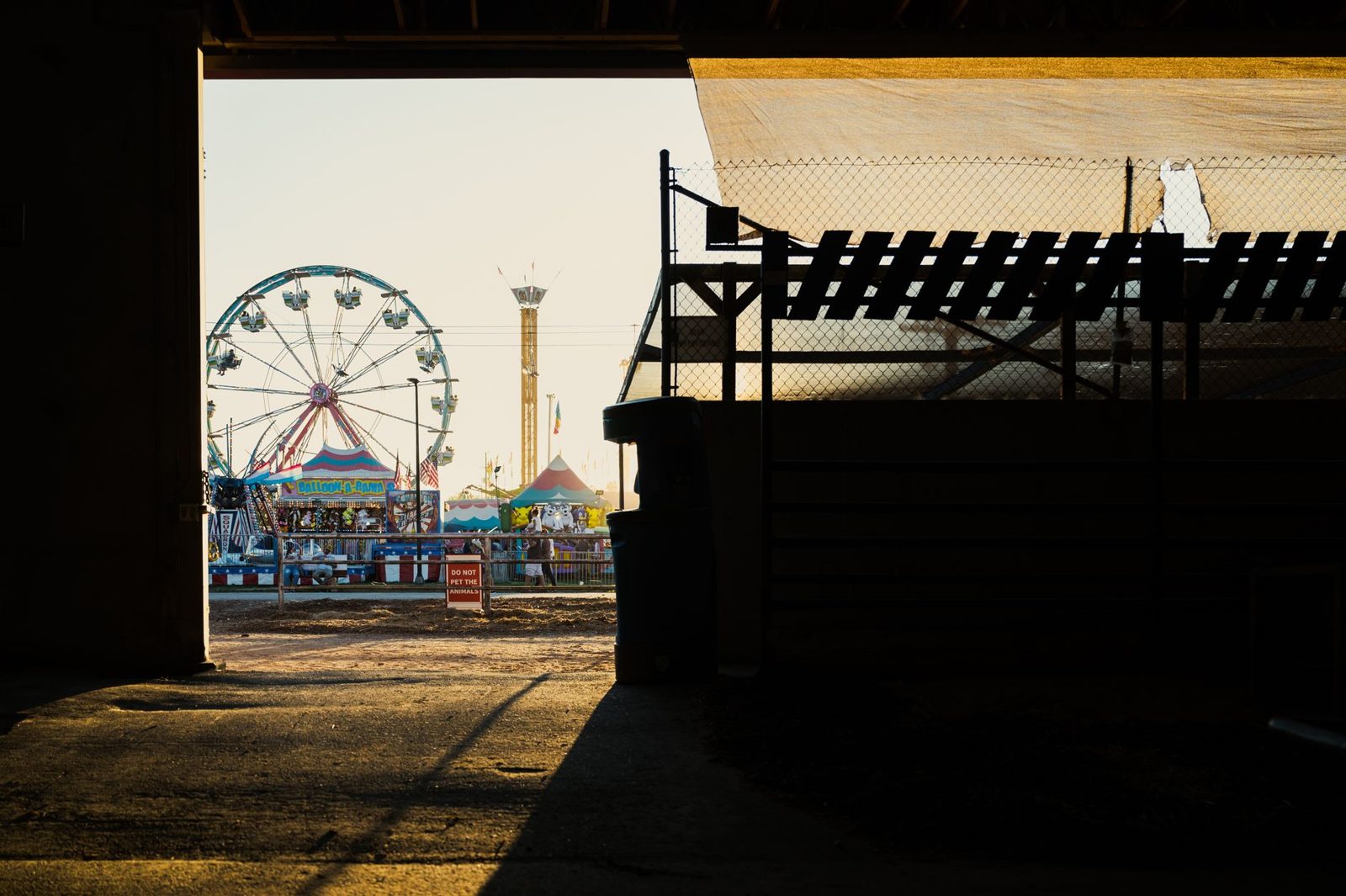 A county fairground seen from inside a barn
